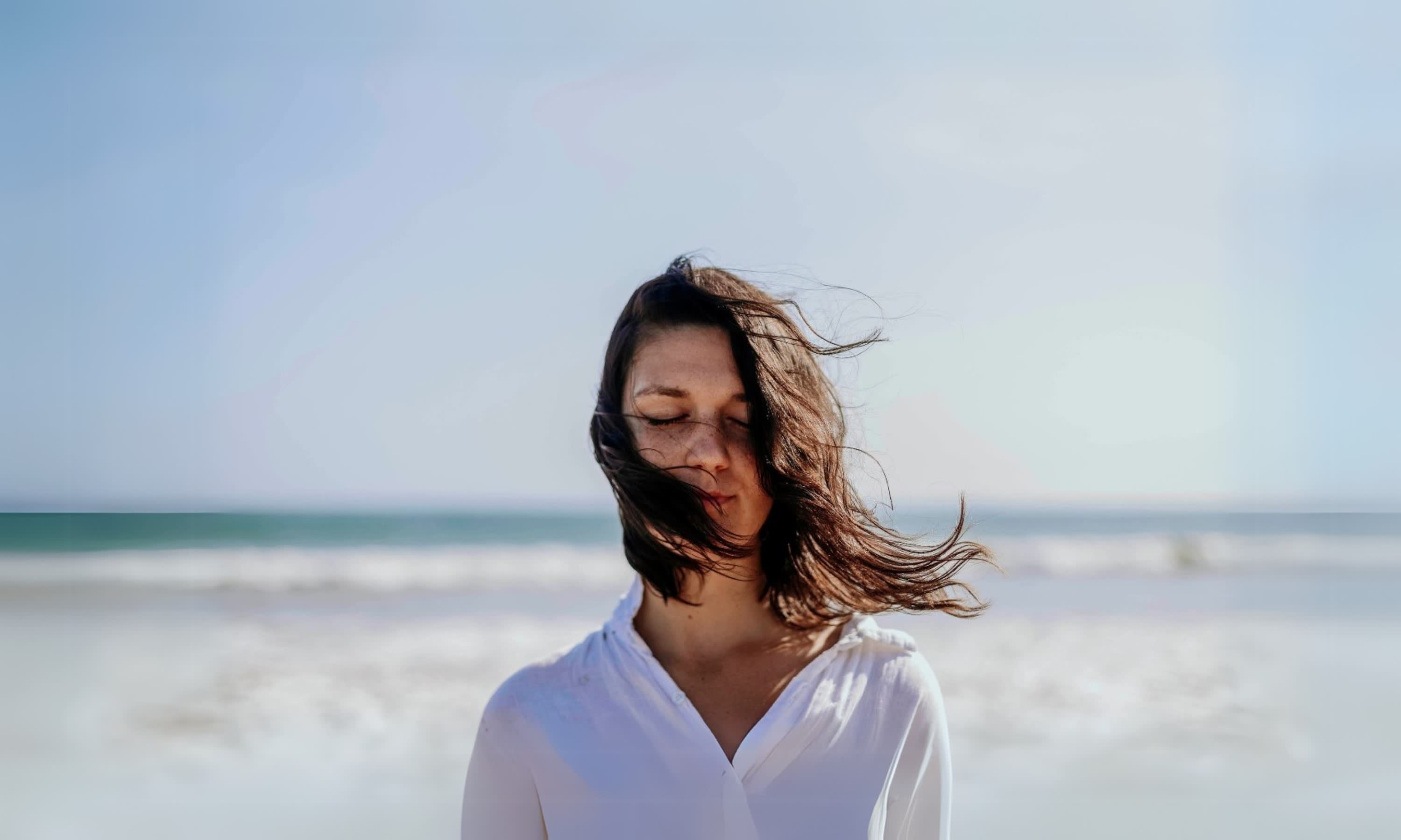 A woman at peace by the ocean